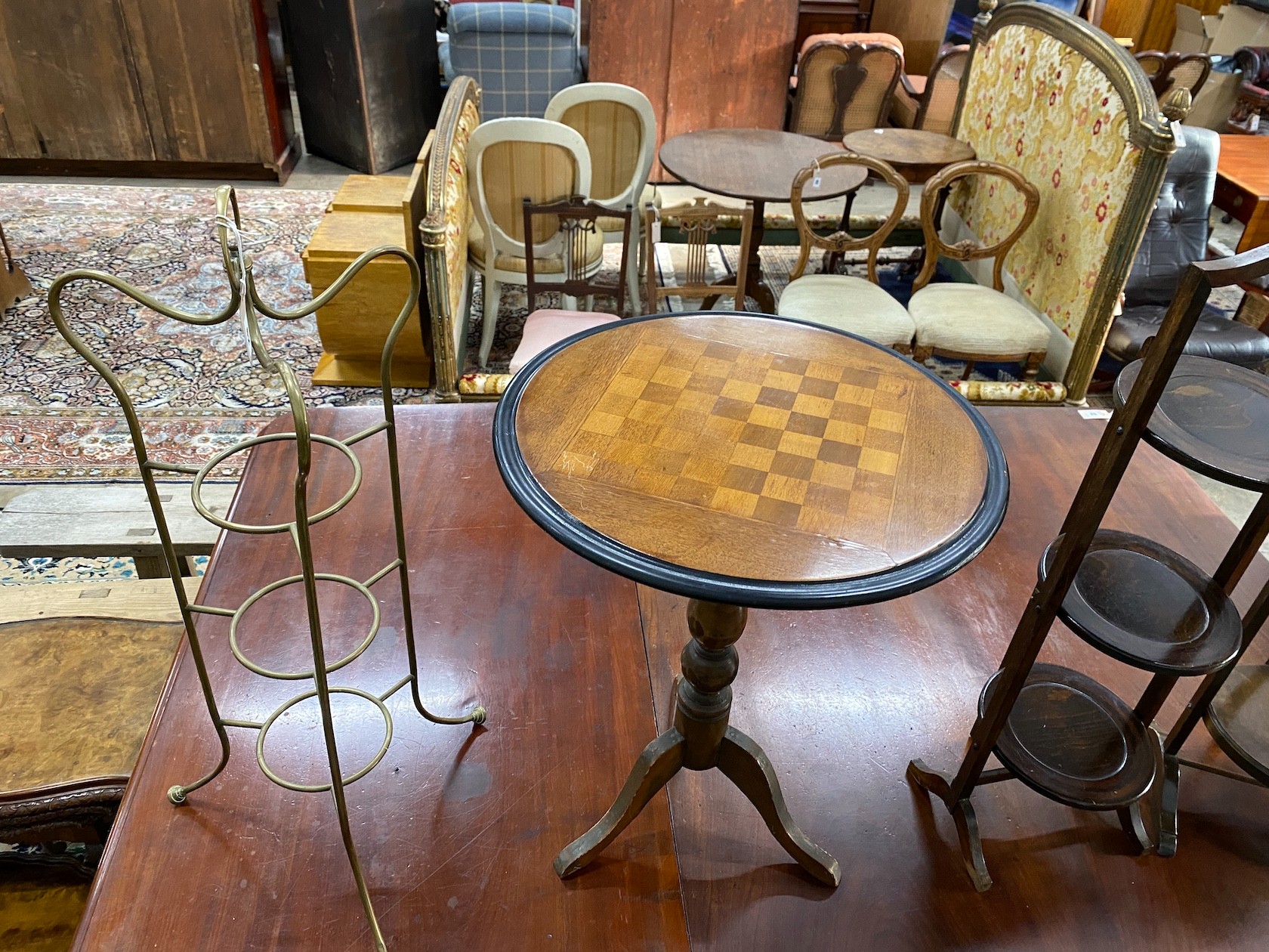 A Victorian style circular tripod games table, diameter 51cm, height 66cm together with three cake stands